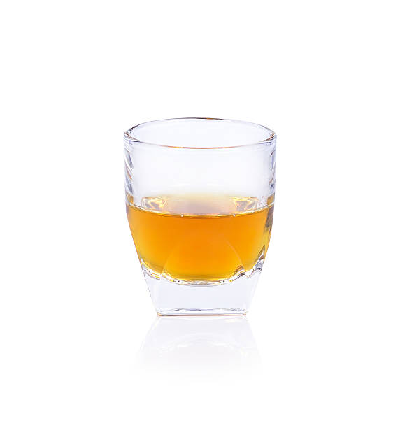 istock Whiskey in a shot glass isolated on a white background 485334764