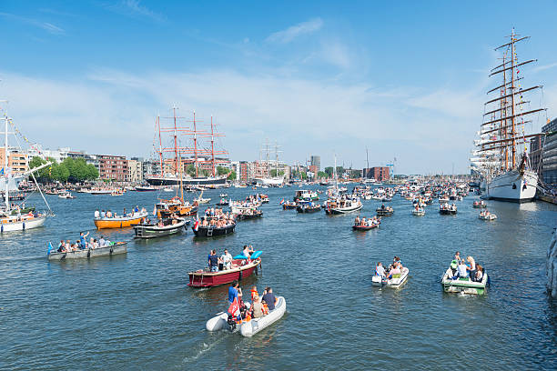 Amsterdam, the Netherlands - August 22, 2015: Color image of a busy day during the SAIL festival in Amsterdam, the Netherlands. SAIL is the biggest festival in the Netherlands. It's a fully public event, visited around 2 million visitors, happening every five years. During the festival world famous tall ships are anchored in the harbour of Amsterdam. Small sailing boats are allowed to sail on the Ij during the festival.