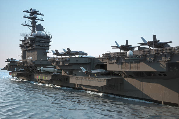 Navy aircraft carrier with a large compartment of aircraft and crew. Navy aircraft carrier angled view, with a large compartment of aircraft and crew. warship photos stock pictures, royalty-free photos & images