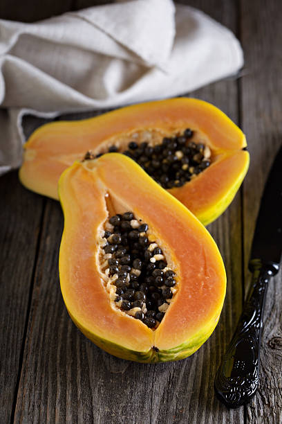 istock Cut papaya on a wooden table 485336236