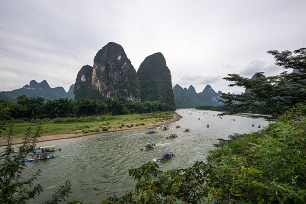 Asia,China,Guilin,Yangshuo,Xingping,Xianggong hill.\nYangshuo is a world famous tourist resort.\nYangshuo is a county of guilin prefecture.\nGuilin karst has been included in the world heritage list.\nHere the Li River snakes through a fairy-tale landscape of conical limestone peaks,its smooth waters exquisitely mirroring the magical.\nStand at the top of the hill to see the Lijiang River,\nLijiang River and its tributaries,the shuttle in the \nShiShanfeng forest,mountains and water and hold,very beautiful.\nBeautiful Lijiang River,is the world's largest and most beautiful karst landscape scenic resort.\nIt's the most beautiful landscape waterway has about 15 km.\nLarge numbers of tourists visit the Li river by yachts every year.