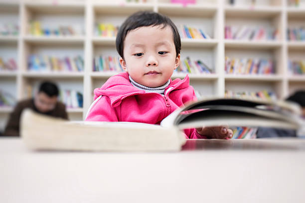 istock Cute asia children in the library 485338511