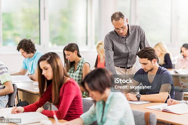 In The Classroom Stock Photo - Download Image Now - A Helping Hand, Adult, Adults Only