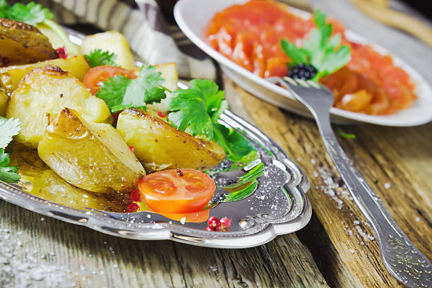istock baked potatoes, fresh vegetables and fish fillets 485341661