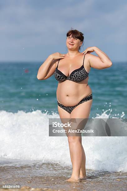 Overweight Young Woman At The Sea Stock Photo - Download Image Now - Overweight, Beach, Women