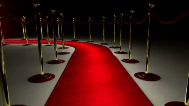 The camera follows a path delimited by an illuminated red carpet, red velvet rope barrier and golden supports. The footpath leads you to a big white door. In the meantime the door is opening and a lots of light illuminates the red carpet and the whole scene. New ways and opportunities are opening in front of you.