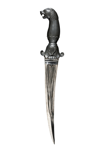 Old dagger vintage with black stone hilt with lions head carved rare and collectible isolated on white.