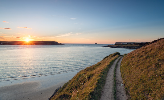 Sunset from the South West Coast Path as it approaches Daymer Bay near Padstow in Cornwall