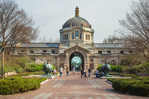 Bronx, New York, USA - April 14, 2014: Landmark Zoo Center Building, formerly Elephant House, at the Bronx Zoo in New York City with visitors present. This world famous zoo opened in 1899. 