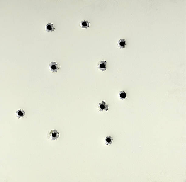 Bullet holes from  firearm in a metal plate Bullet holes from  firearm in a metal plate penetration stock pictures, royalty-free photos & images