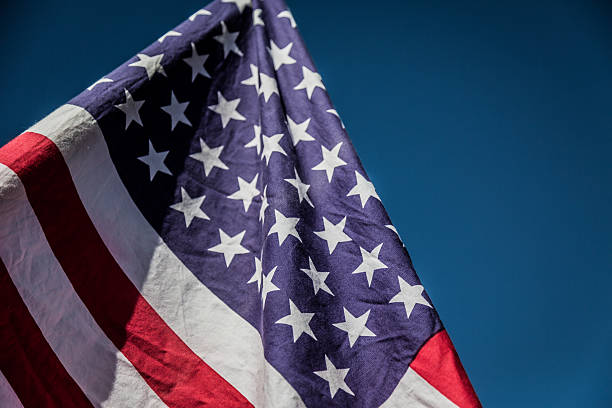 istock American flag over blue sky 485347388