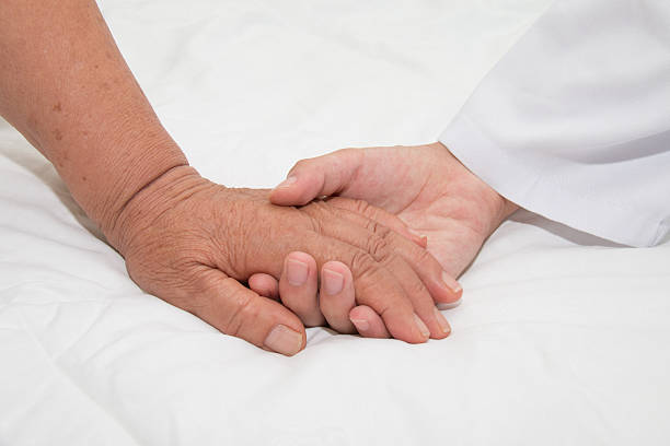 istock Doctor holding an old woman's hand 485348074