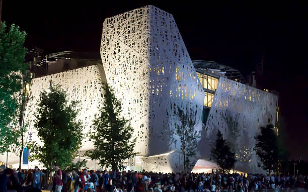 Milan, Italy - May 14, 2015:  Crowd of people at night under white Italian pavilion at Expo 2015