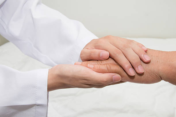 istock Doctor holding an old woman's hand 485348628