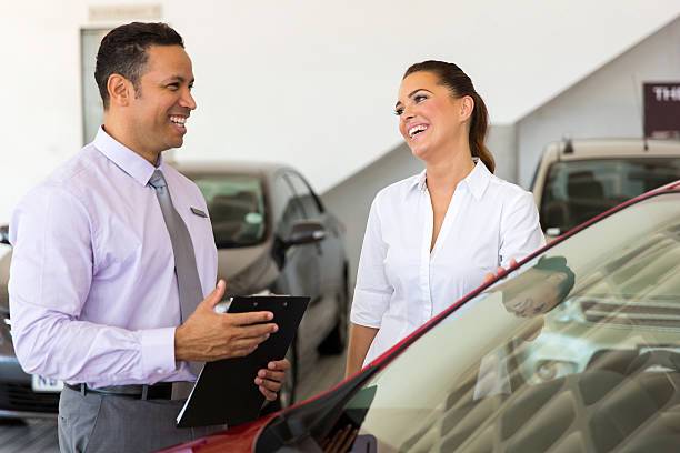 istock middle aged car salesman talking to a customer 485349042