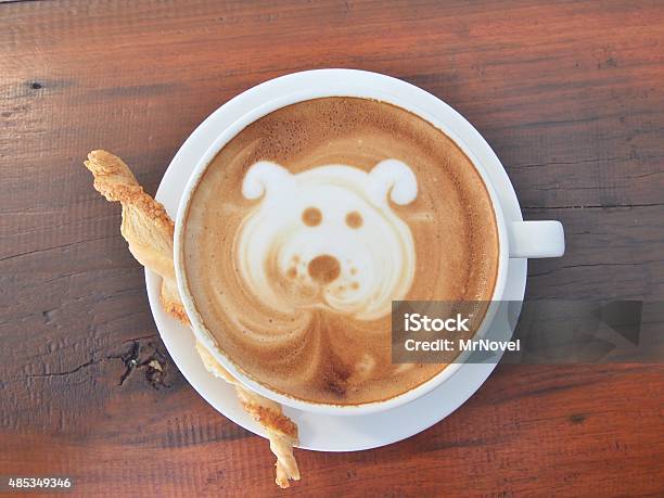 Latte Coffee Art And Biscuit Stick On The Wooden Desk Stock Photo - Download Image Now