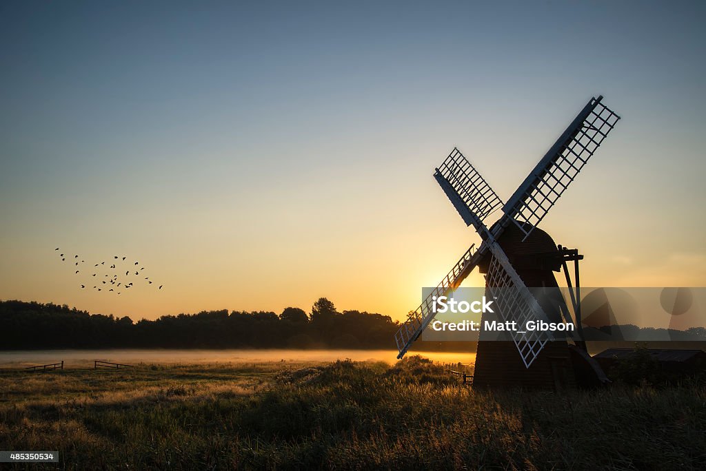 Old windmill in foggy countryside landscape in England Old windmill in foggy English countryside landscape 2015 Stock Photo