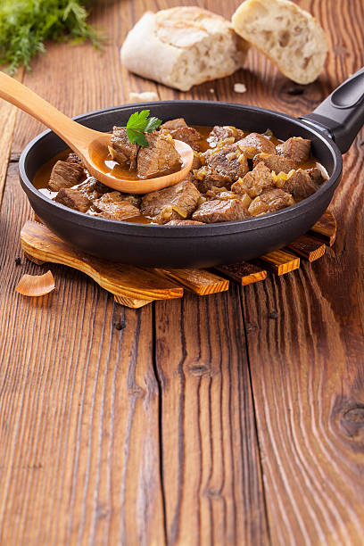 istock Beef stew - wooden background 485350854