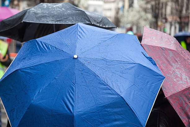 istock people with rain umbrellas in the city 485352008