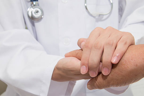 Doctor holding an old woman's hand