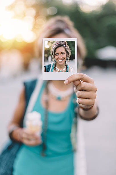 istock Girl holding instant photo 485357470