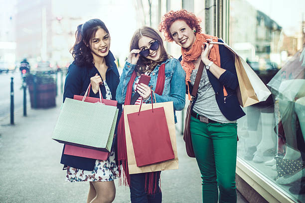 istock Laughing young women posing with shopping bags 485357528