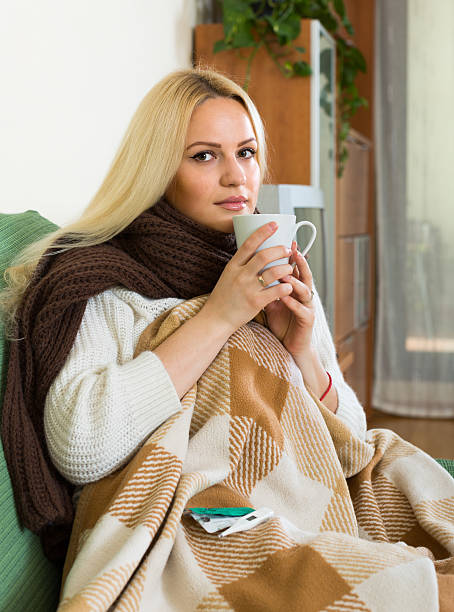 istock Woman sitting under plaid 485357584
