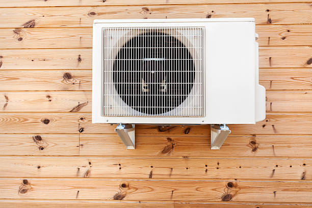 istock Exterior airconditioning unit on a wooden wall 485358598