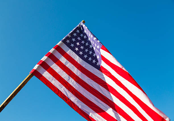 istock American flag over blue sky 485358800