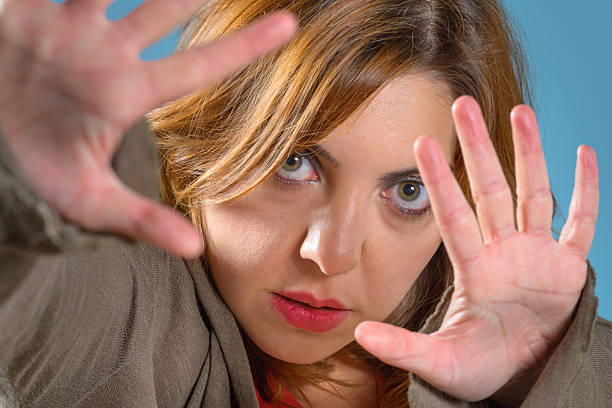 istock Frightened young woman defend herself 485359870