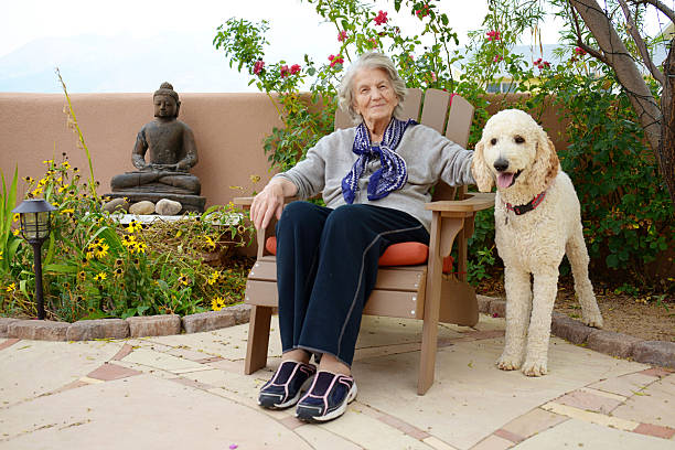 istock Senior Woman with Therapy Dog, Resting 485363334