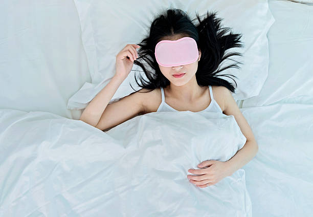 istock woman sleeping in sleep mask 485363568