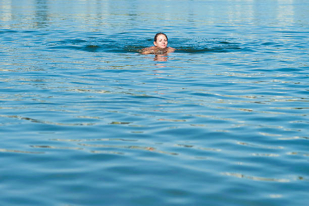 istock Girl swimming in river 485364022