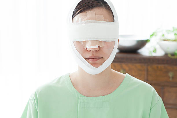 istock Woman with bandages around head 485365054