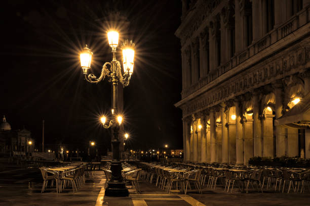 Deserted cafe in St Mark's Square at night stock photo