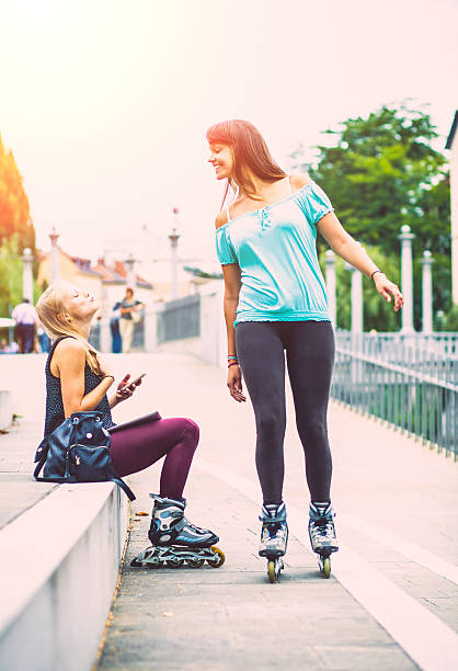 istock Best friends bonding together and having fun with rollerskates 485365232