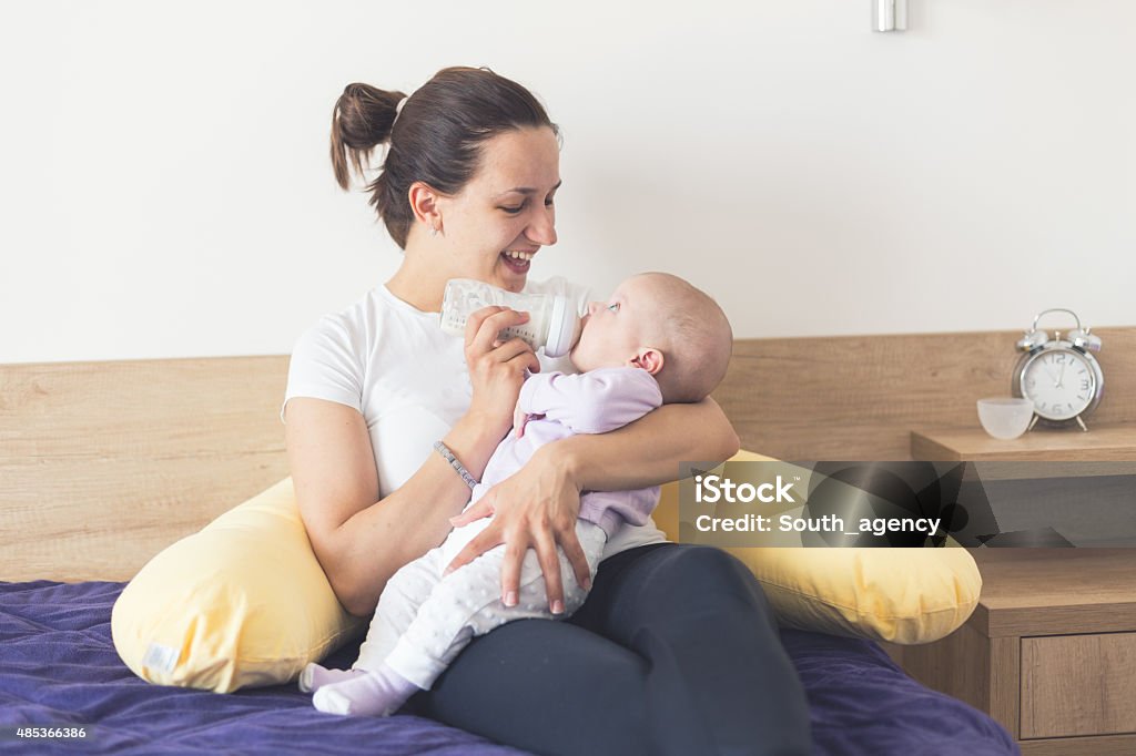 Mother Bottle-Feeding Her Baby Mother feeding her newborn baby with a bottle of milk Baby - Human Age Stock Photo