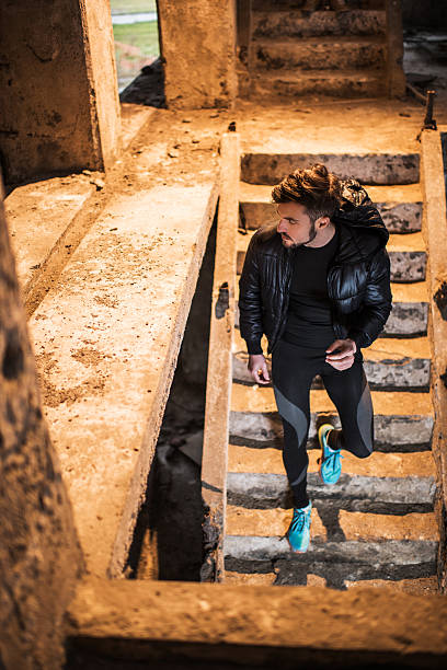 istock Above view of a young man running down the stairs. 485367182
