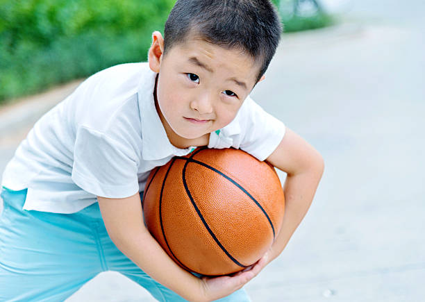 istock Little boy holding a basketball 485367528