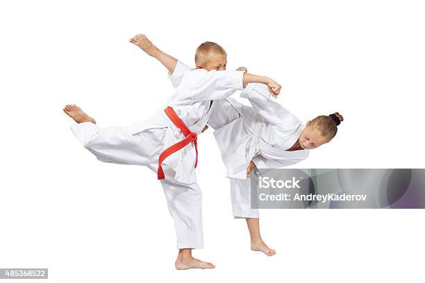 Boy And Girl Are Trained Karate Blows Stock Photo - Download Image Now - 2015, Activity, Belt