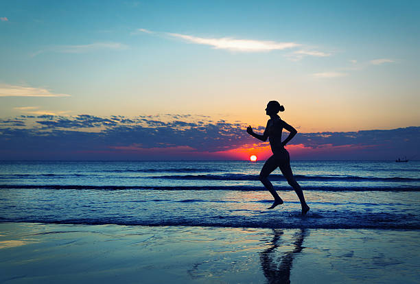 istock Girl runing  along the sea coast 485370131