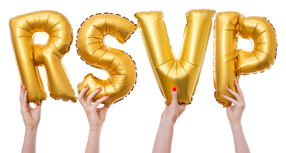 The word RSVP has been created by female hands holding individual letter balloons. Each balloon is being held against a plain white background by a caucasian female hand. The Balloons are inflated and made from a shiny reflective gold material.