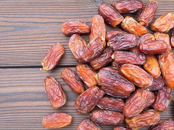 istock Dried dates on the wooden planks 485371358