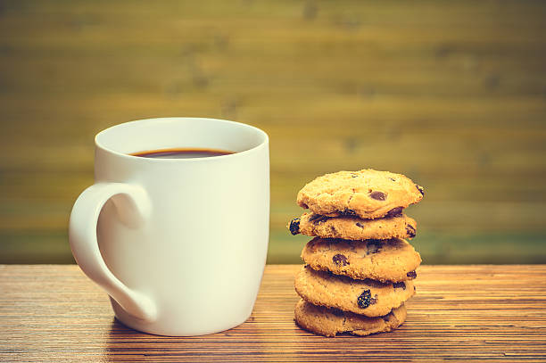 istock White cofee cup with batch of cookies 485371435