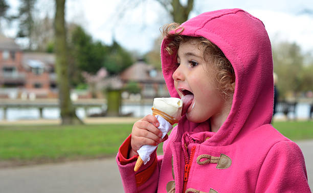 istock Child eating ice cream with coat on 485371621