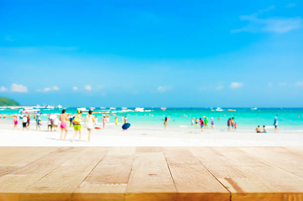 istock Table top on blurred background of people at the beach 485374248