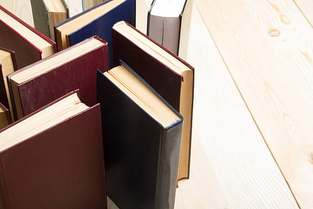 istock Top view of old used colorful hardback books. 485374820