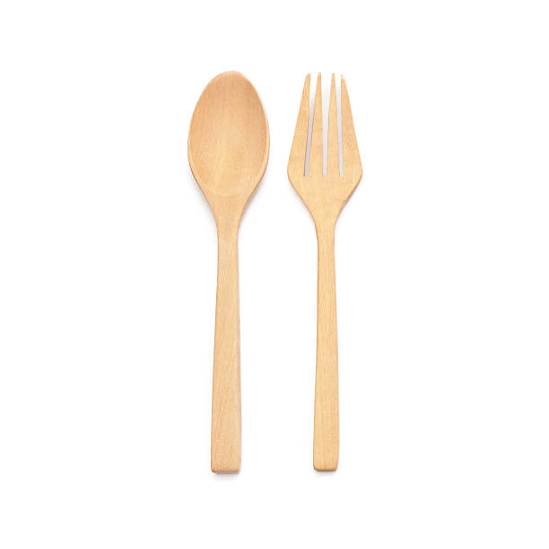 istock brown wooden spoons and fork on white background 485375270