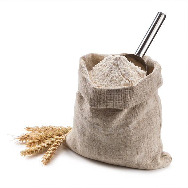 istock flour in a bag and spikelets isolated on white background 485375798
