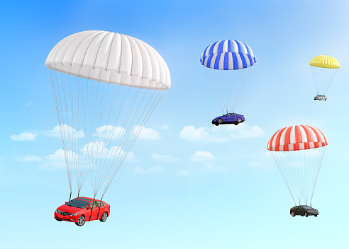 Concept of leasing. Fast delivery car. Cars falling on the parachutes on a sky background.